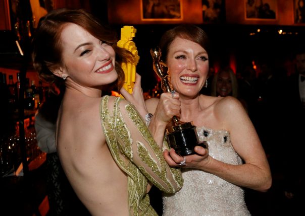 Actress Stone compares her Lego Oscar statuette with actress Moore's genuine Oscar for best leading actress for her role in "Still Alice" at the Governors Ball following the 87th Academy Awards in Hollywood